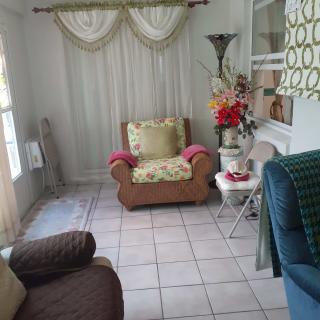 A cozy living room setup with an armchair, decorative curtains, and a lamp.