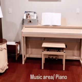 A cozy music area featuring a piano with sheet music and a stool.