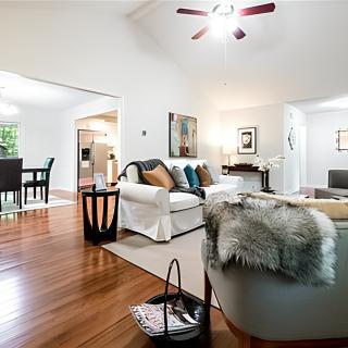 A modern and bright living room with stylish decor and hardwood flooring.