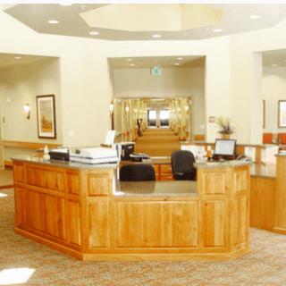 A well-lit reception area with wooden furniture and office equipment.