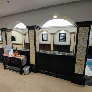 A modern reception area featuring elegant design with artwork and furniture.