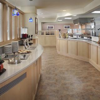 A spacious buffet area with multiple counters in a restaurant setting.