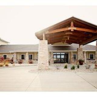 A modern building entrance with stone and wood architectural elements.