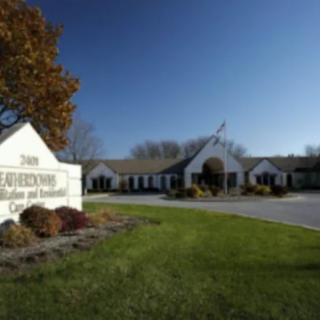 A clinic building with a prominent sign on a sunny day.