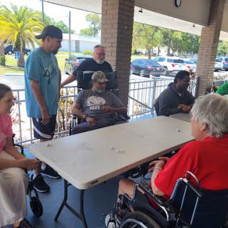 A group of people enjoying games and socializing outdoors.