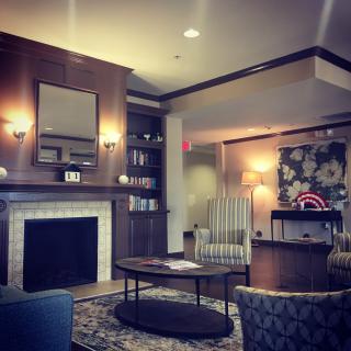A cozy living room with a fireplace, comfortable seating, and decorative elements.