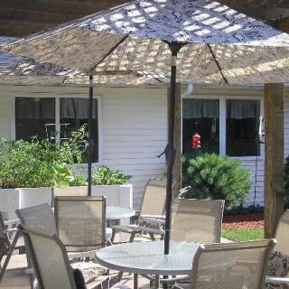 Outdoor patio with table, chairs, and a large umbrella.