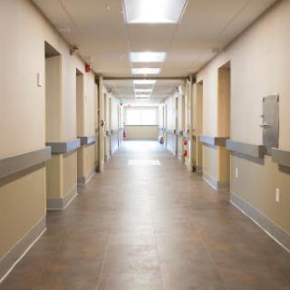 A well-lit hospital hallway showcasing a clean and organized healthcare environment.