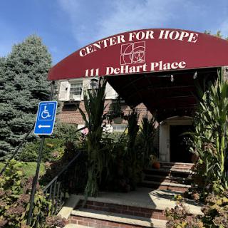 The entrance of the Center for Hope, featuring accessible parking and vibrant landscaping.