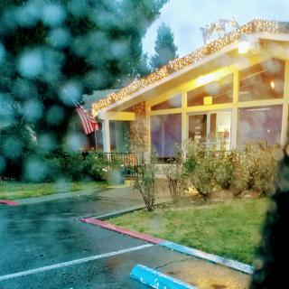 A cozy restaurant illuminated on a rainy evening.