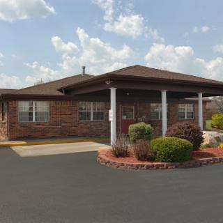 A beautifully landscaped brick building with a welcoming entrance.