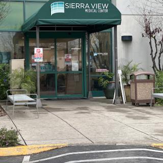 Entrance of the Sierra View building with a welcoming green awning.