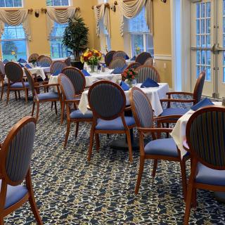 An elegant dining room with neatly arranged tables and chairs, featuring a stylish interior design.