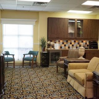 A cozy waiting room featuring comfortable seating and a bright window.