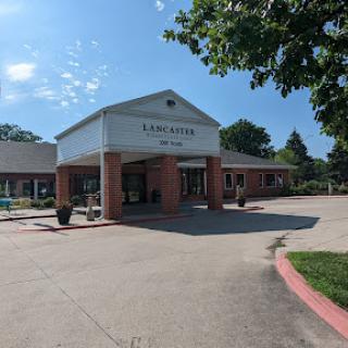 A welcoming entrance to a community facility surrounded by greenery.