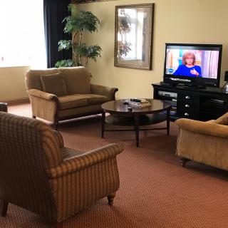 A cozy living room with comfortable seating and a television.