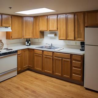 A well-organized kitchen with wooden cabinets, a refrigerator, stove, and sink.