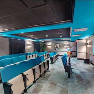 A modern home theater with comfortable blue seating and stylish interior design.
