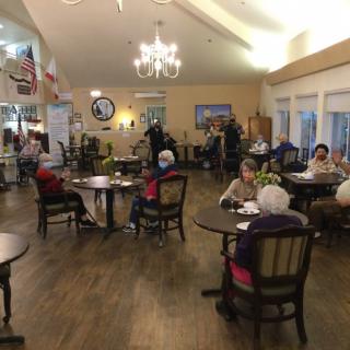 A cozy dining area with people socializing around tables.