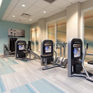 A modern gym with various exercise machines.