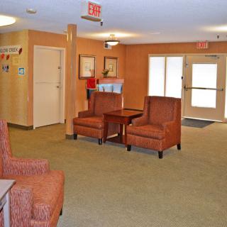 A cozy lobby with comfortable seating and warm lighting.