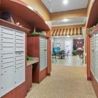 A hallway with mailboxes in an office lobby setting.