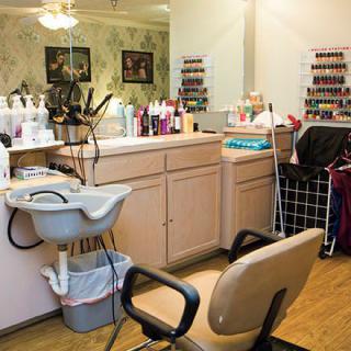 A beauty salon interior with hair styling stations and a variety of haircare products.