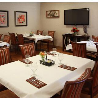 A cozy dining area set up for guests, featuring elegant tables and chairs.