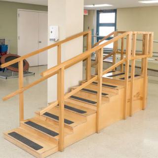 A set of stairs used for physical rehabilitation exercises in an indoor setting.