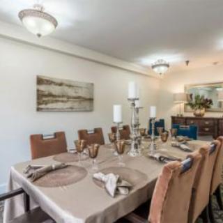 An elegantly decorated dining room with a formal table setting.