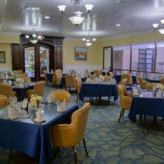 A well-arranged dining room with neatly set tables and comfortable chairs.