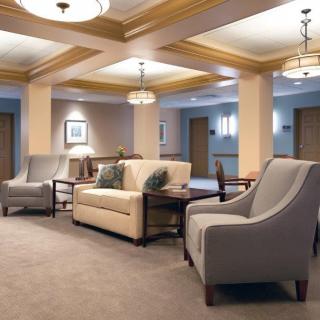 A hotel lobby with comfortable seating and elegant lighting.