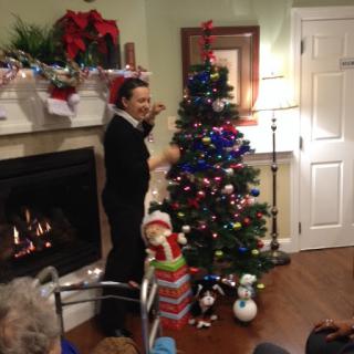 A festive gathering with a decorated Christmas tree and warm ambiance.