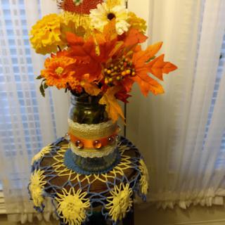 A vibrant arrangement of artificial flowers in a decorative vase, adding a touch of color to the room.