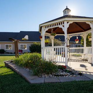 A charming gazebo surrounded by well-maintained landscaping, basking in the warm sunlight.