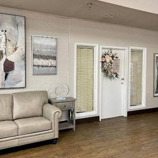A cozy living room featuring a stylish sofa and elegant wall art.