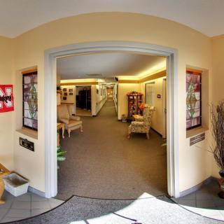 A welcoming hallway with archway entrance and cozy decor.