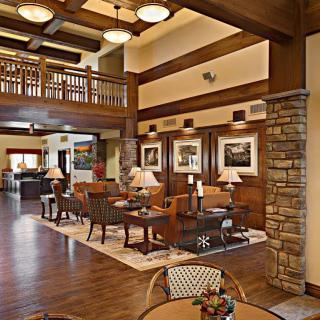 A spacious lobby with elegant wooden architecture and comfortable seating areas.