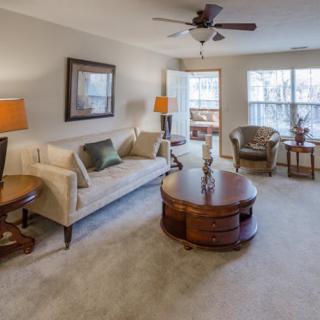 A cozy living room featuring a comfortable sofa, coffee table, and warm lighting.