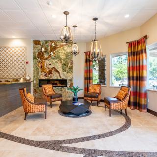 A stylish living room with modern seating, a fireplace, and decorative lighting.