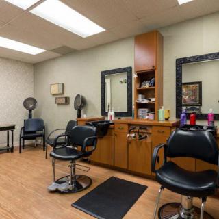 A well-organized hair salon with styling chairs and mirrors.