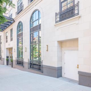 Modern building exterior with large windows and decorative elements.