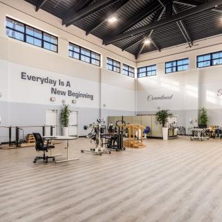 A spacious modern workspace with high ceilings and industrial-style design.