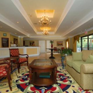Luxurious hotel lobby with elegant chandeliers and comfortable seating.