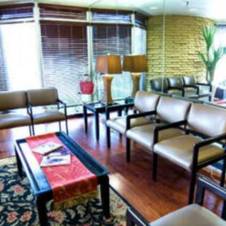 A cozy waiting room with comfortable seating and warm lighting.