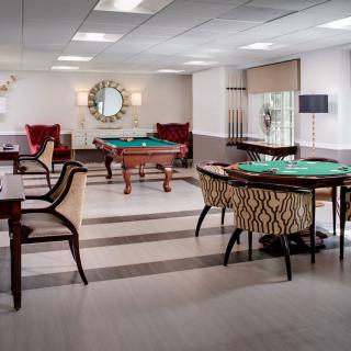 A stylish indoor game room featuring billiards tables and comfortable seating.