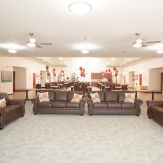 A spacious living room setup with multiple sofas and stylish decor.