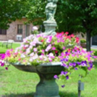 A decorative garden fountain filled with colorful flowers.