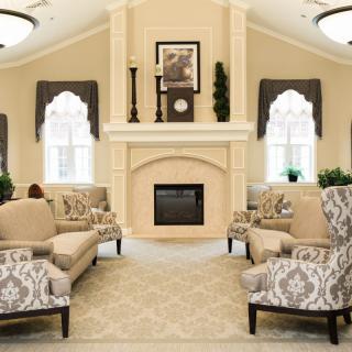 Elegant living room with a central fireplace and comfortable seating.