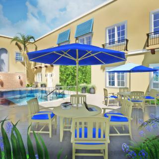 A sunny outdoor patio area with blue umbrellas and chairs around a pool.